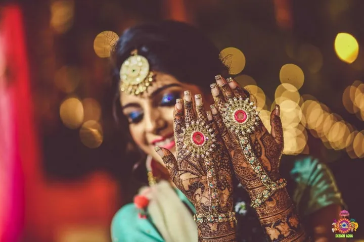 Bride Posing Back Hand Floral Mehndi Design with Diamond Jewellery
