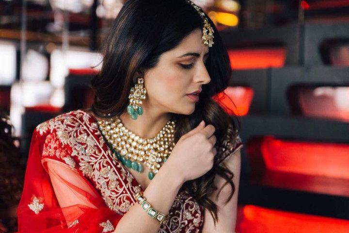 Free Photos - A Beautiful Indian Woman Wearing Traditional Red And Gold  Jewelry. She Is Dressed In A Red Sari, Adorned With Ornate Necklaces,  Earrings, And A Stylish Bracelet On Her Arm.