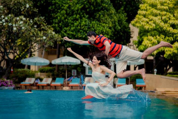 Luxury Resort Swimming Pool With Silhouette Of Couple Looking At Sunset  Stock Photo, Picture and Royalty Free Image. Image 205109513.