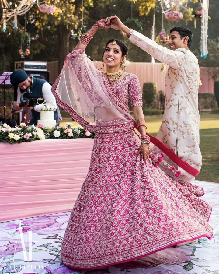 Photo of Contrasting bride and groom with bride in chevron lehenga