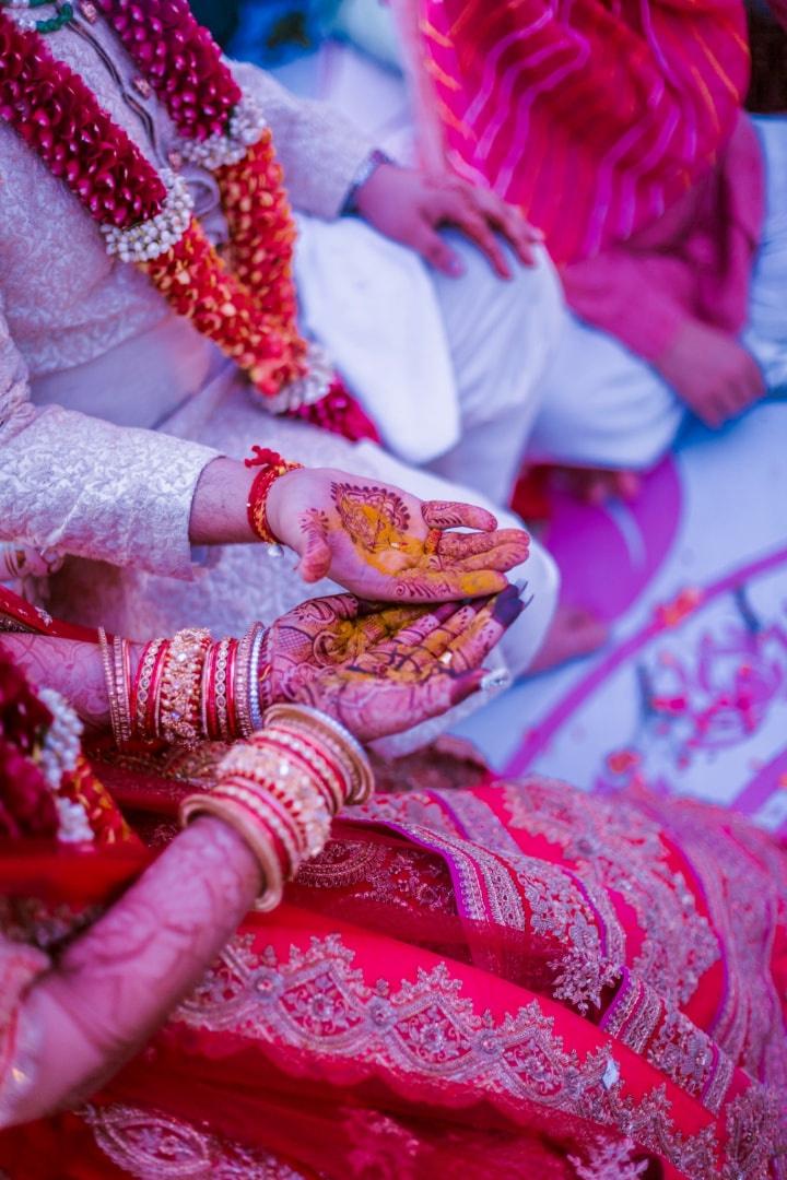 Indian bride showing Mehndi design and gold bracelet and colorful bangle  Stock Photo | Adobe Stock