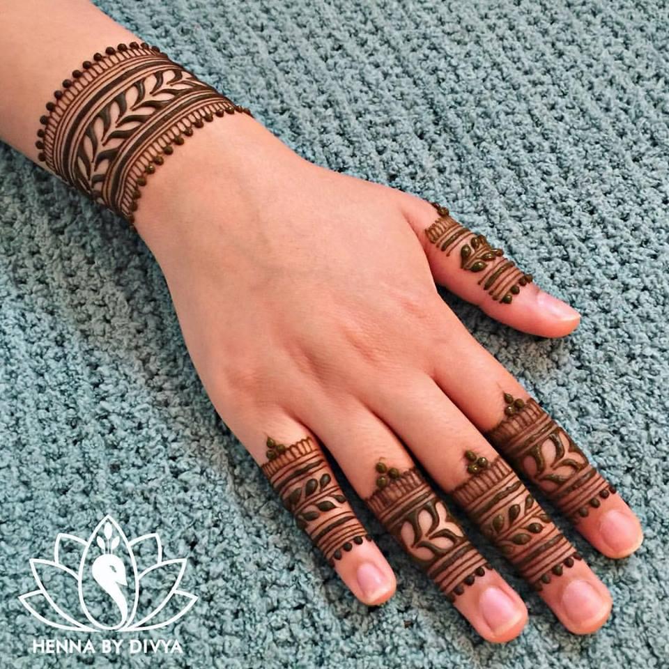 Premium Photo | Process of applying mehndi on female hands