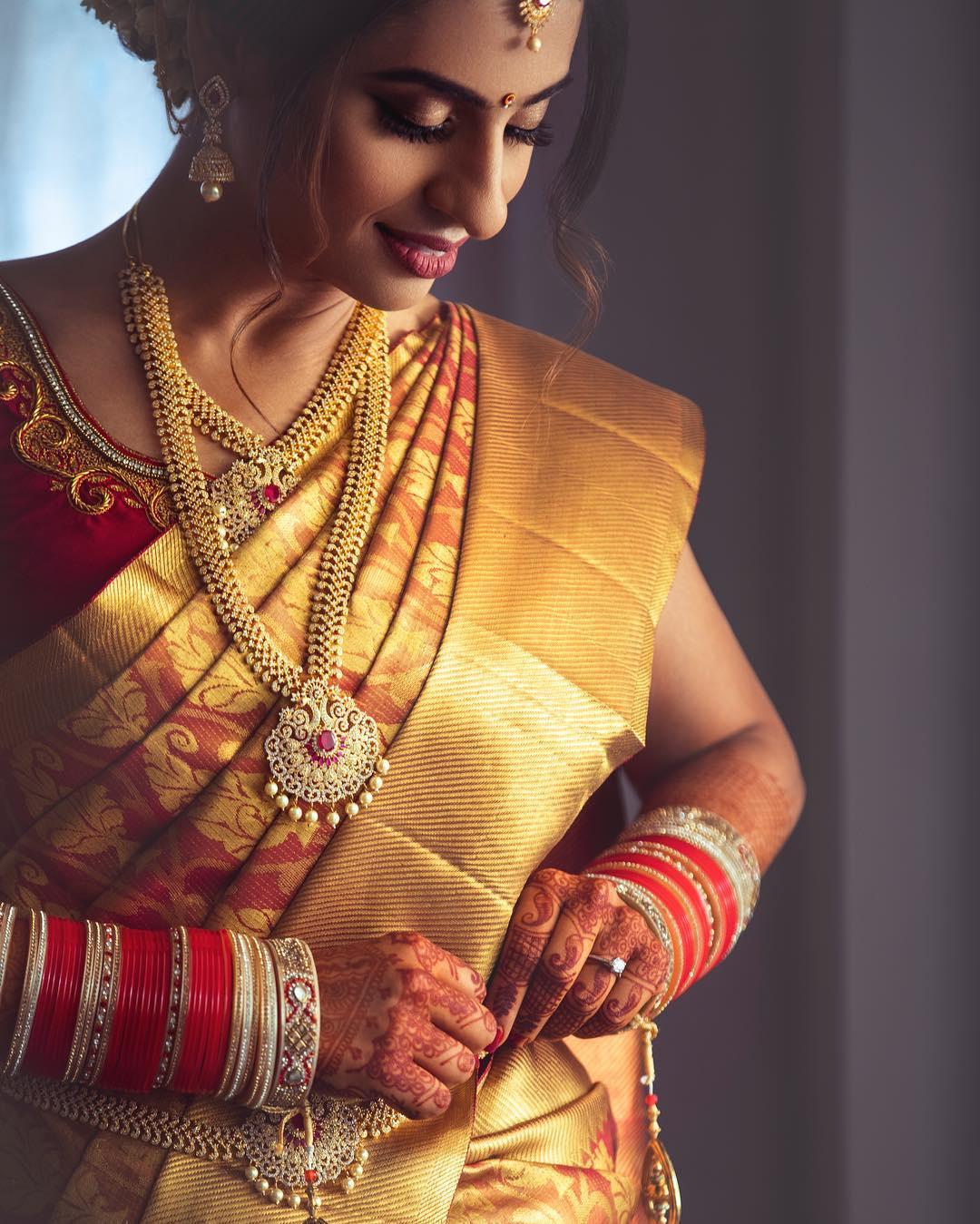 Photo of south indian bridal look in pink kanjivaram with twist hairdo