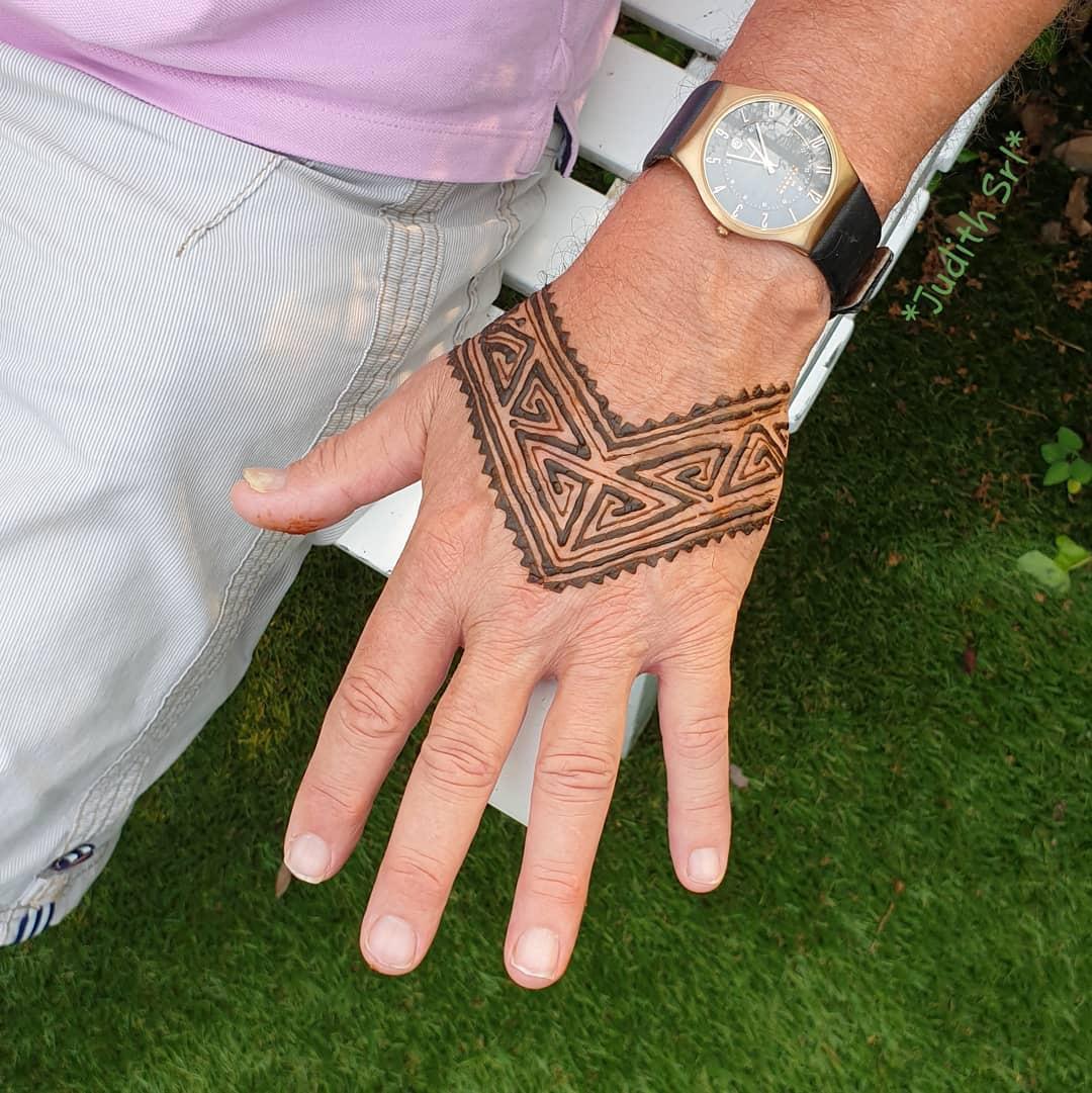Man having a traditional henna tattoo applied to his arm in Jambiani  Zanzibar Stock Photo  Alamy