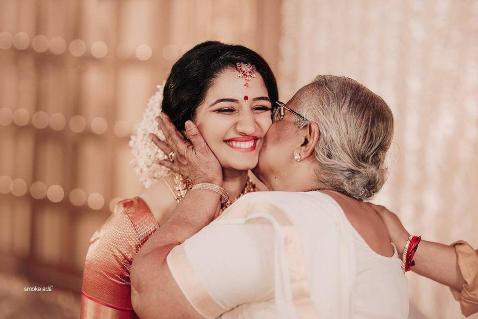 mother kissing the bride