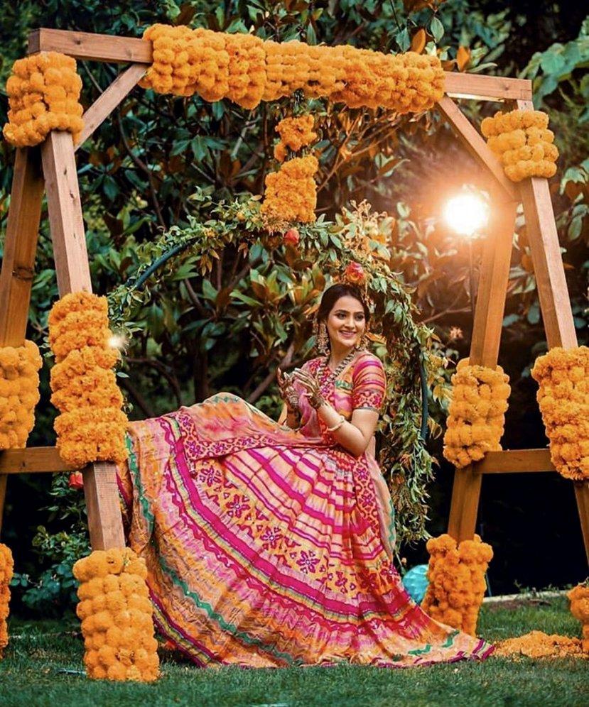 Photo of Mehendi jhoola decor with marigolds