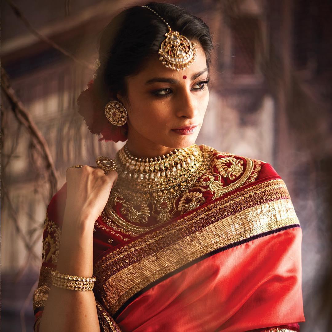 Photo of South Indian bride in a red and gold saree.