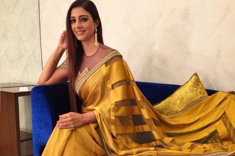 Free Photos - An Indian Woman Wearing A Yellow Saree, An Elegant And  Traditional Indian Garment, Along With Gold Jewelry, Including Multiple  Necklaces And Earrings. She Is Posing For A Picture, Showcasing