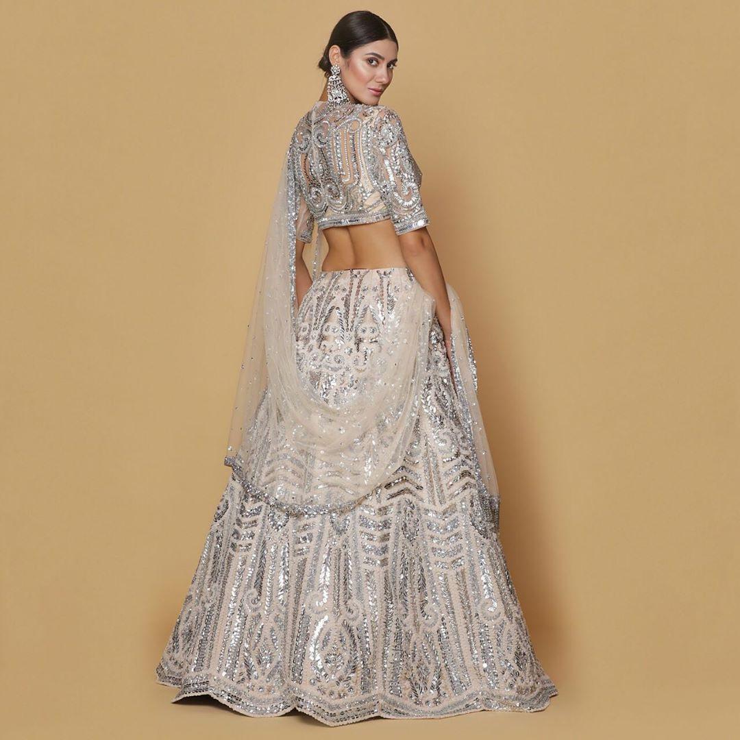 Gold lehenga with multicolored resham work by Neeta Lulla