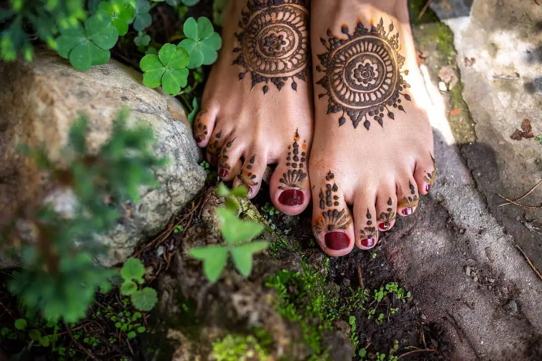 Closeup Of Female Legs And Hands With Henna Tattoo On The Feet Black And  White Photo Gently Feminine Graceful Decoration Respect For A Woman Love  And Take Care Of Yourself Stock Photo