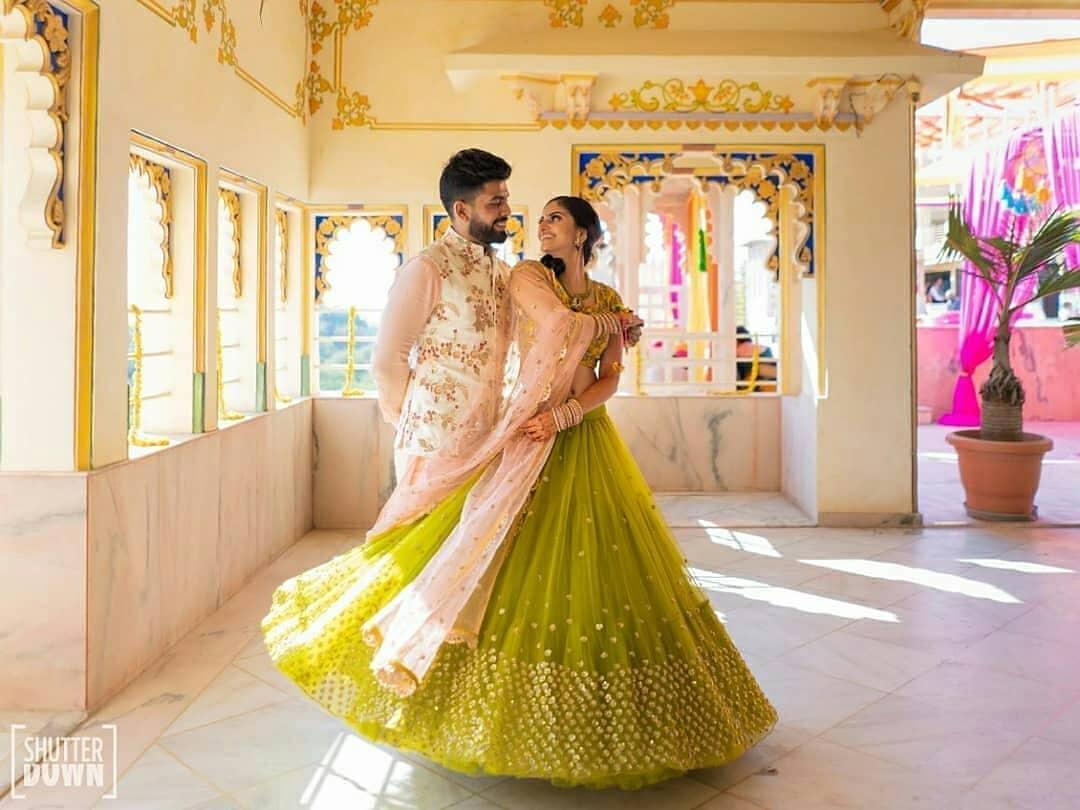 Photo of Mehendi couple shot with bride in light green lehenga