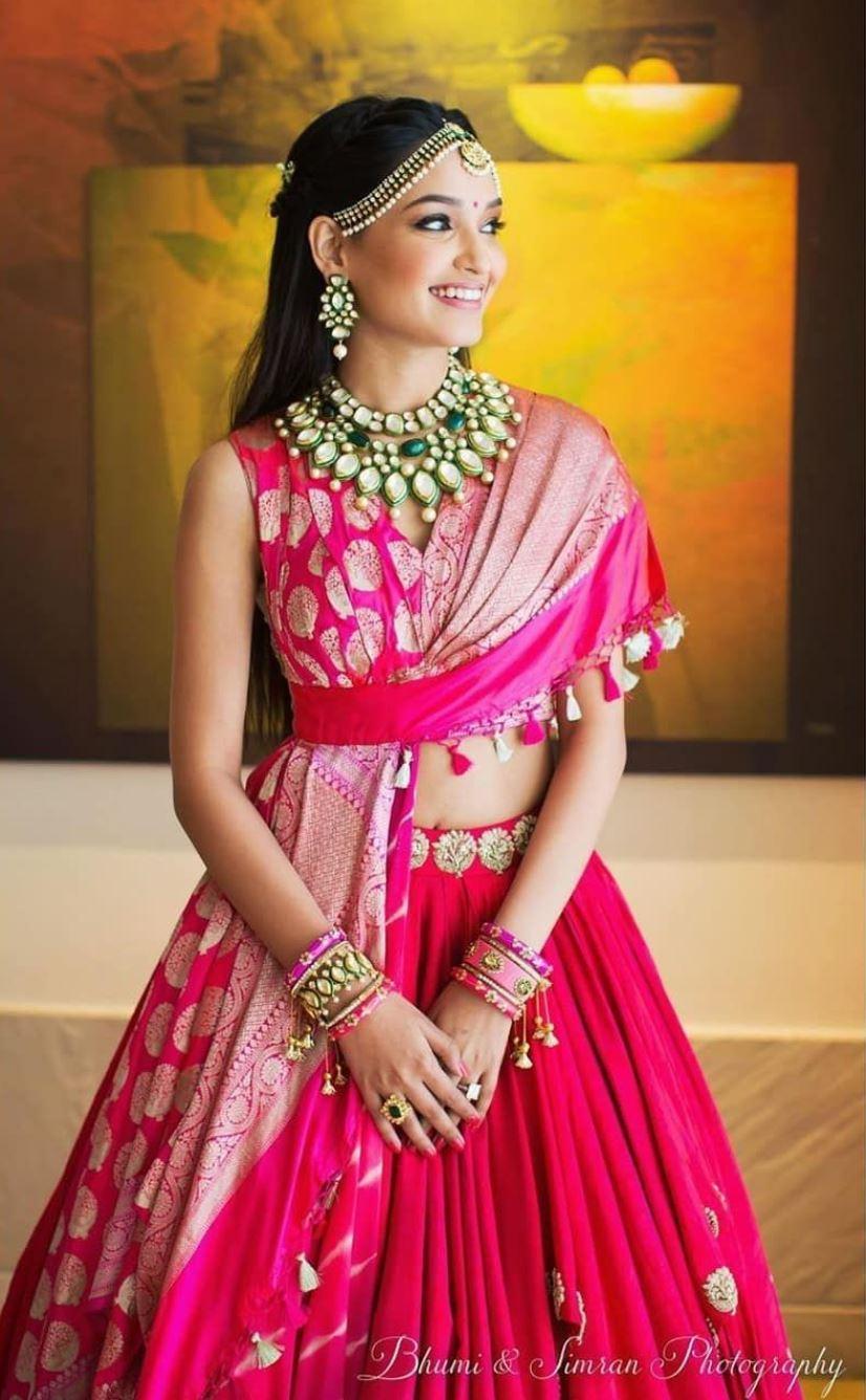 GRACEFUL PLEATED BANARASI LEHENGA CHOLI IN PINK ORGANZA - HALFSAREE STUDIO  - 4213968