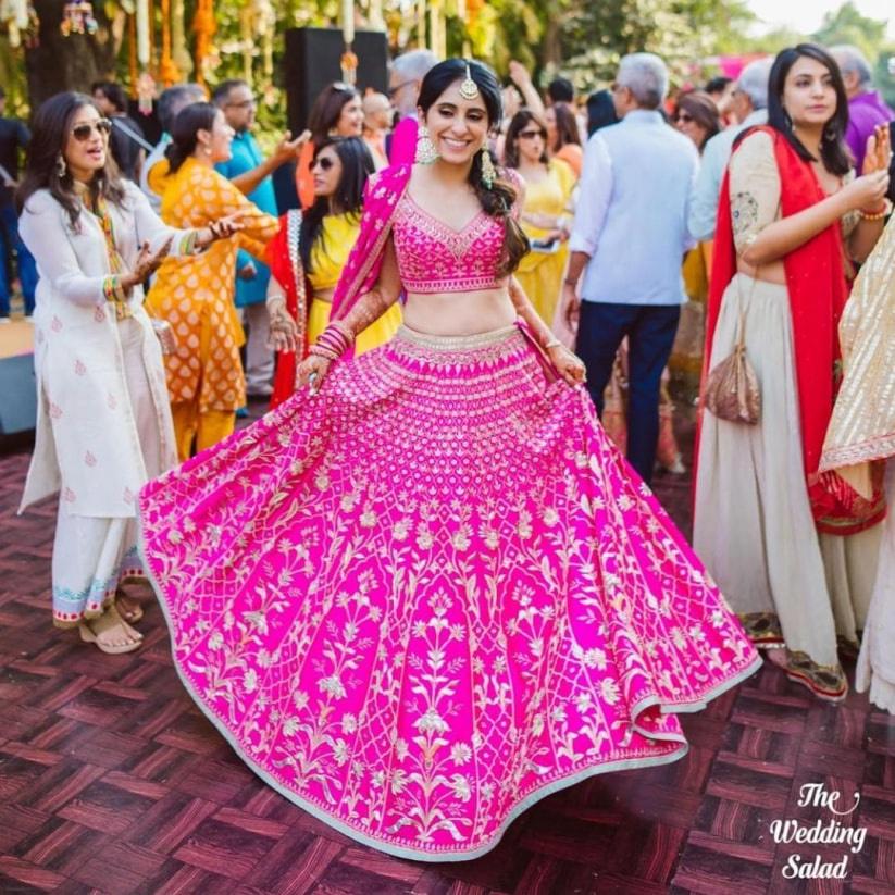 Photo of red and blue bridal lehenga with unique latkans