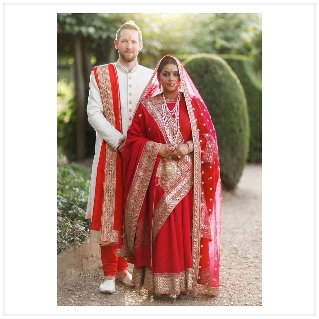 Photo of Contrasting bride and groom outfits in red and white