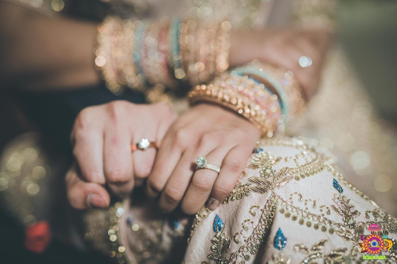 Photo of Romantic couple shot showing off rings