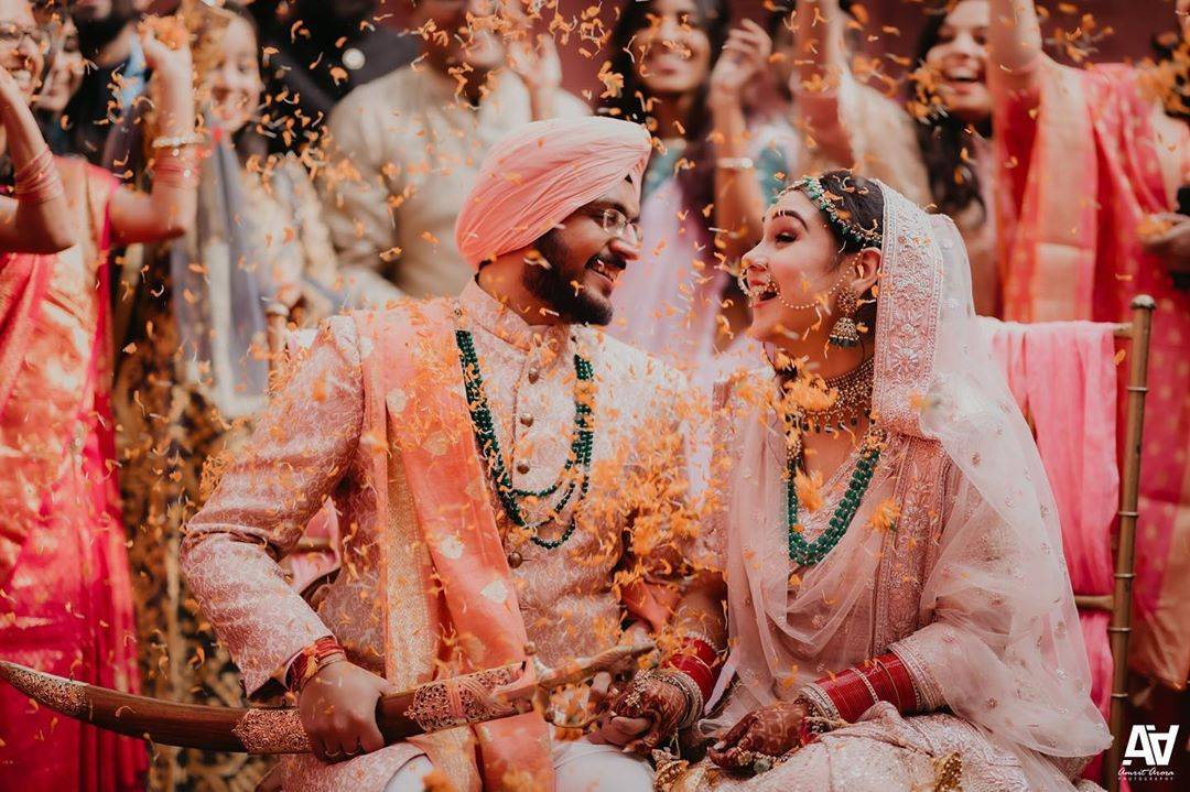 indian punjabi wedding couple holding hands