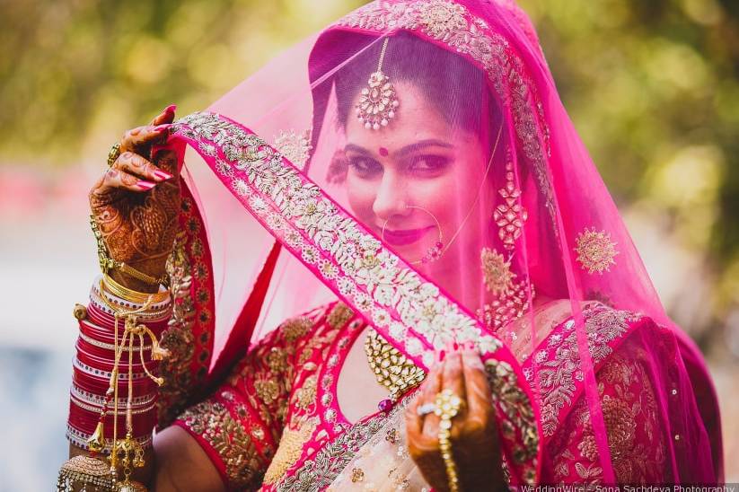 Bride Wore A Gorgeous Ivory Lehenga With A Unique Blouse And Pink 'Chooda'  | Indian wedding garland, Indian wedding flowers, Bride wear