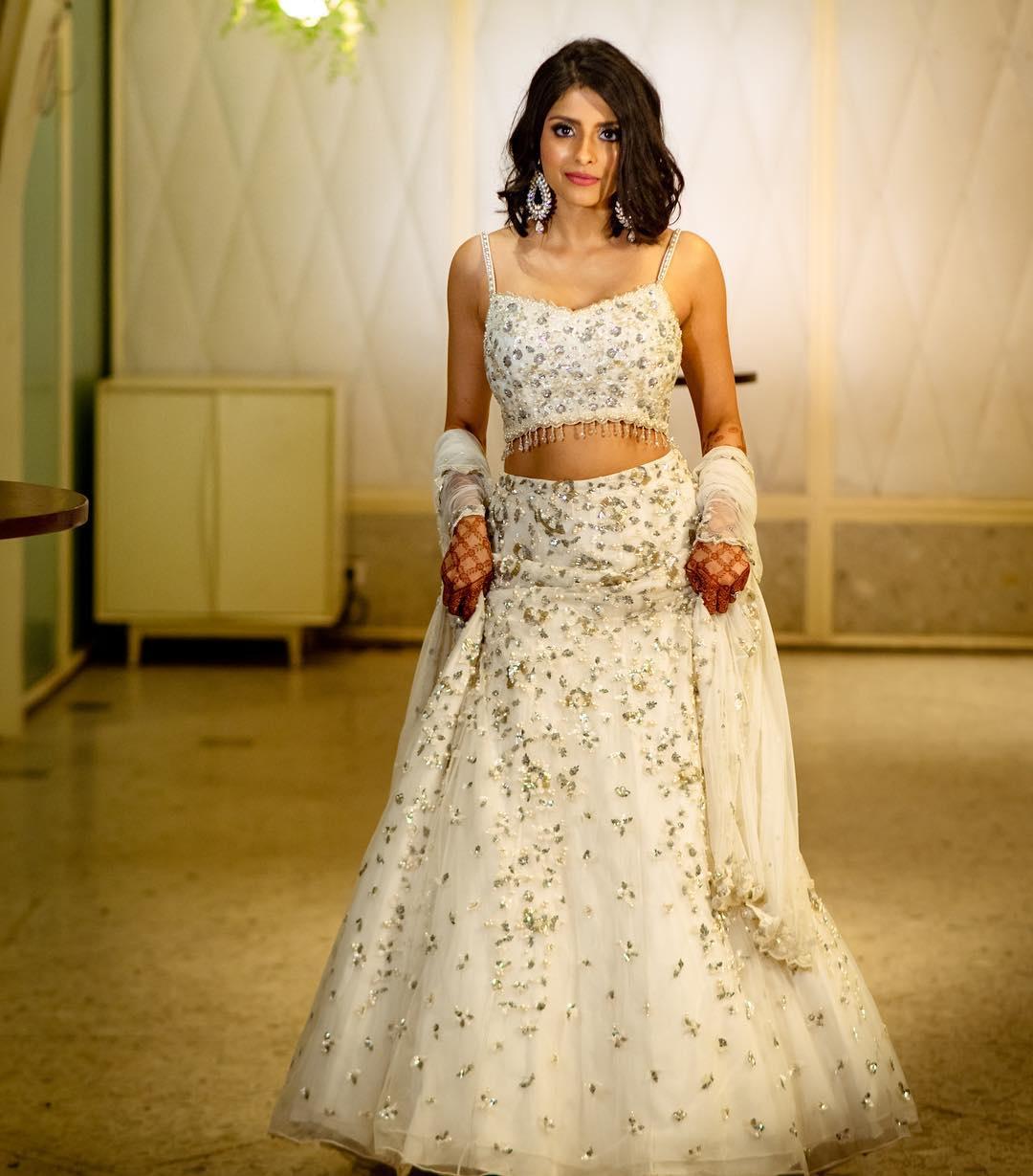 Photo of Bride in red lace lehenga for reception