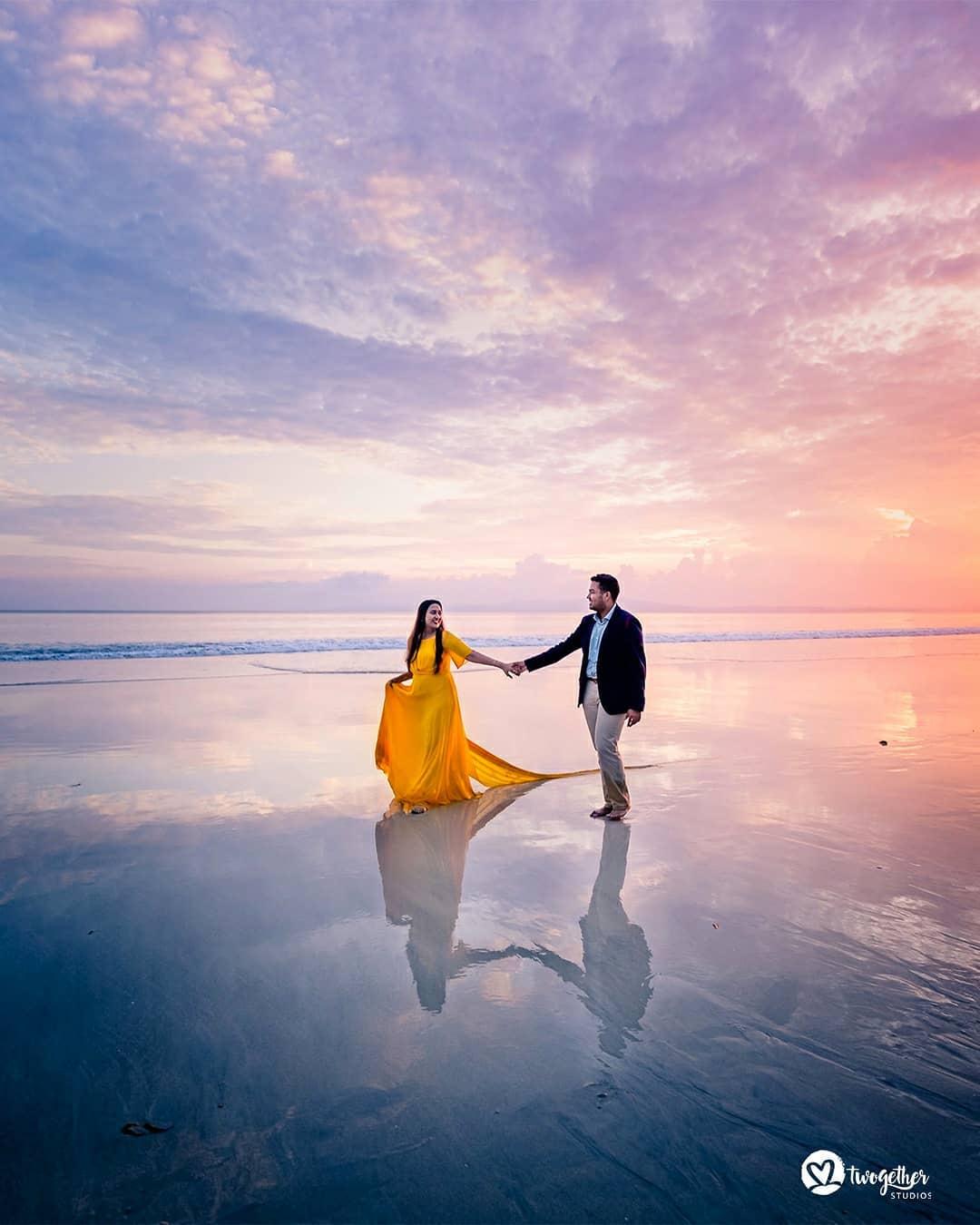 Indian couple in traditional attire by the beach side Stock Photo - Alamy