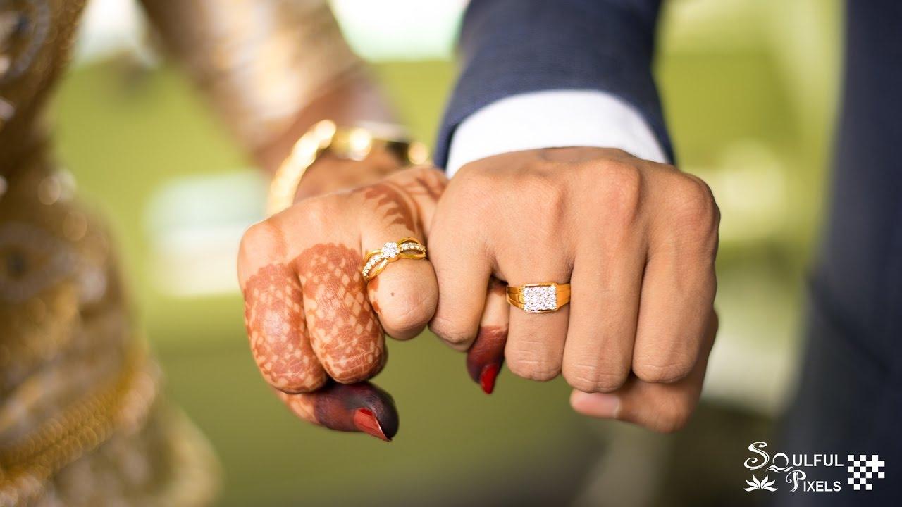 Wedding engagement rings. Newlywed couple's hands with engagement rings.  Young couple at ceremony. Stock Photo by maxbelchenko