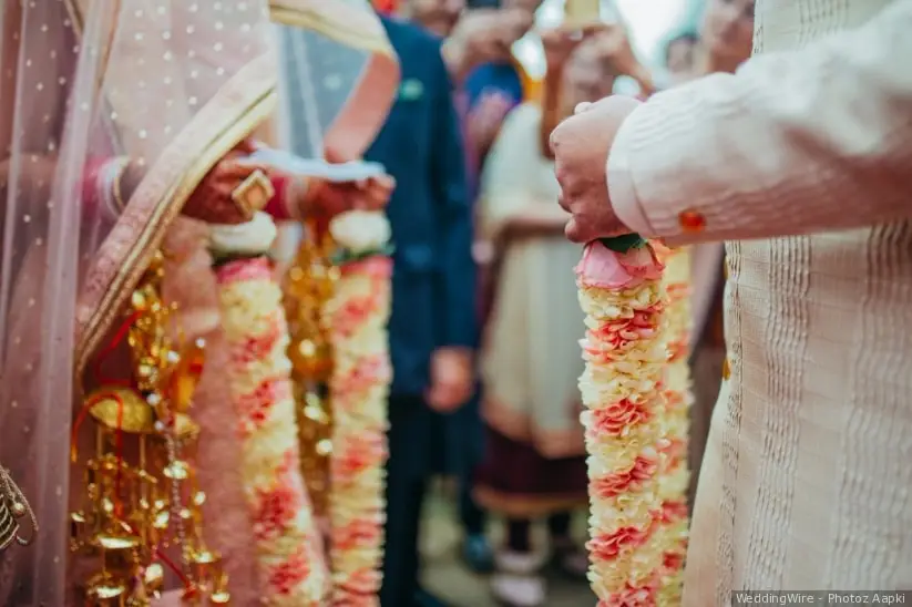 The bride and groom at the Indian wedding garlands or Jaimala ceremony  Stock Photo | Adobe Stock