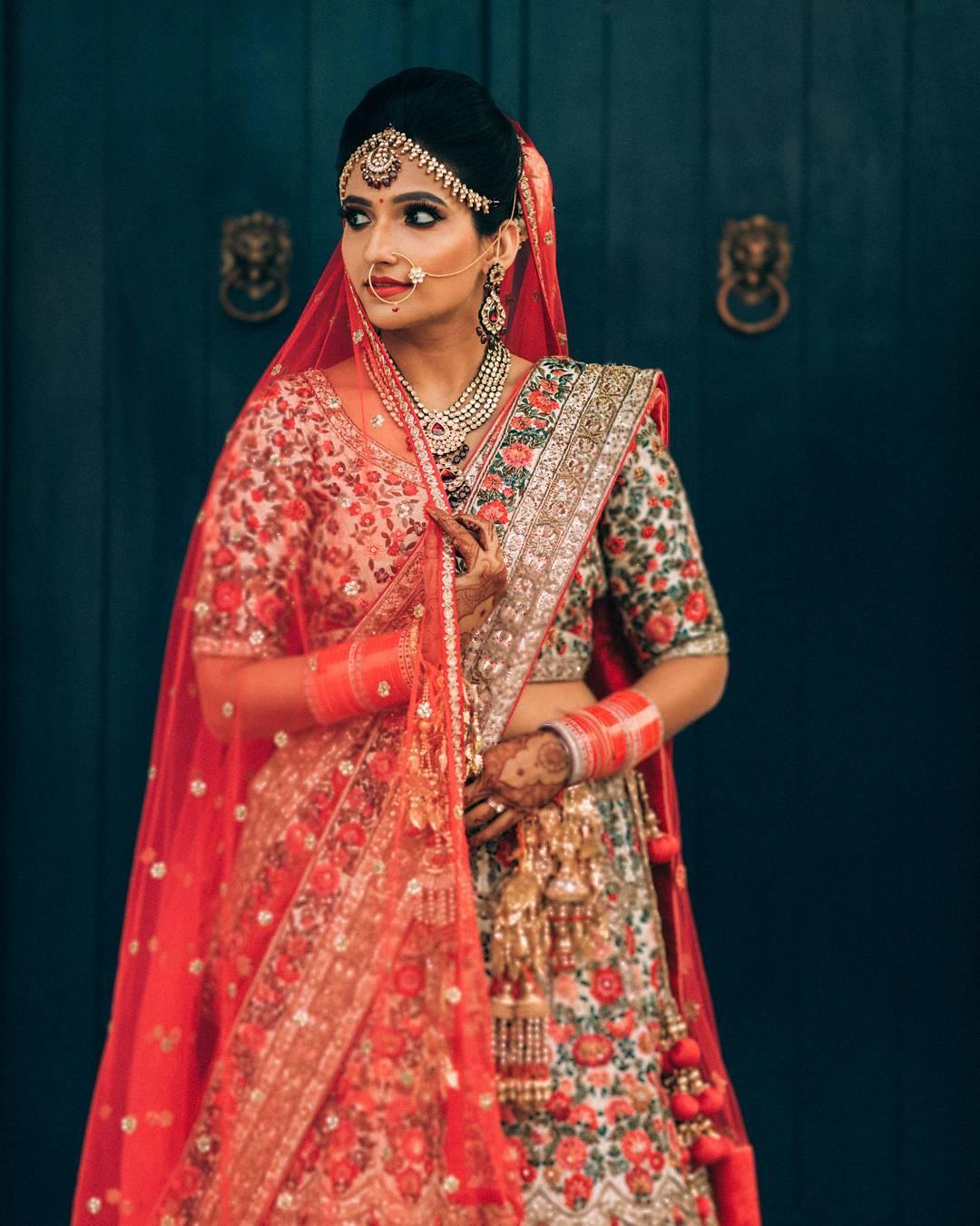 Photo of Bride in light grey and peach bridal lehenga