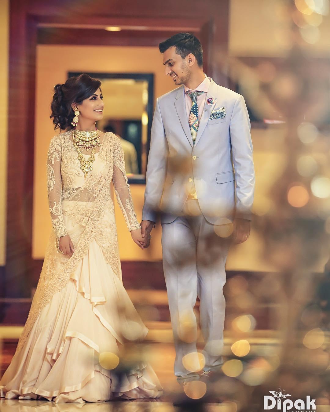 Our beautiful client Astha Arya looked surreal at her engagement ceremony  in a hazel gold gown accentuated with a bustier styled with a floor-length  embroidered cape. Astha's gown is encrusted with micro