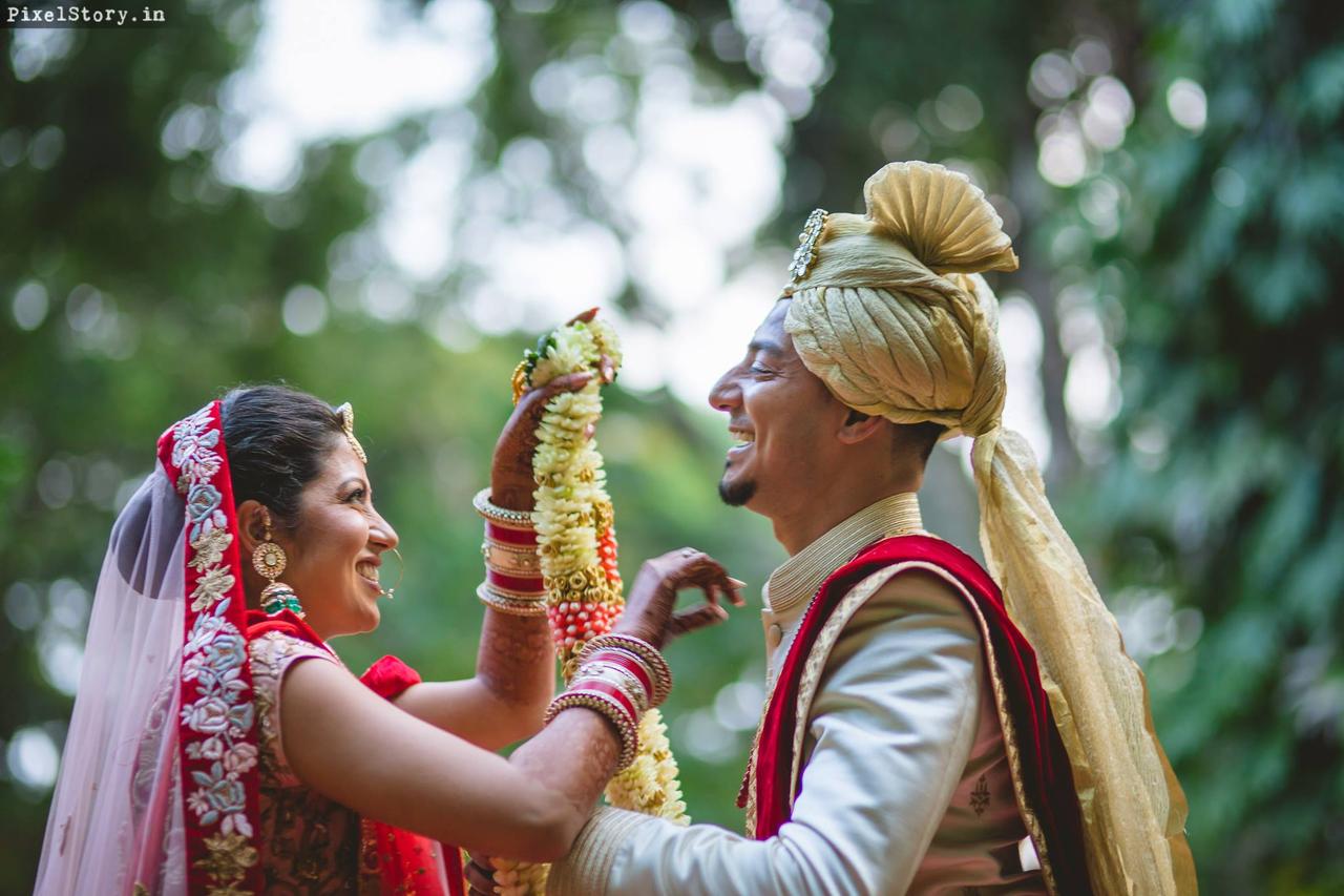 Portrait Of An Indian Wedding Couple Posing In Front Of Camera During  Wedding Ceremony High-Res Stock Photo - Getty Images