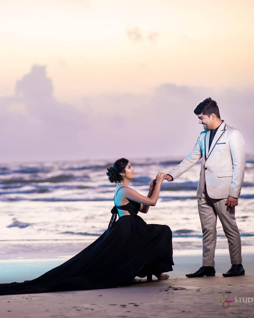 Premium Photo | Portrait of a fabulous couple posing on a sandy beach next  to a tropical shining sea, looking at each other with loving eyes. romantic  concept.