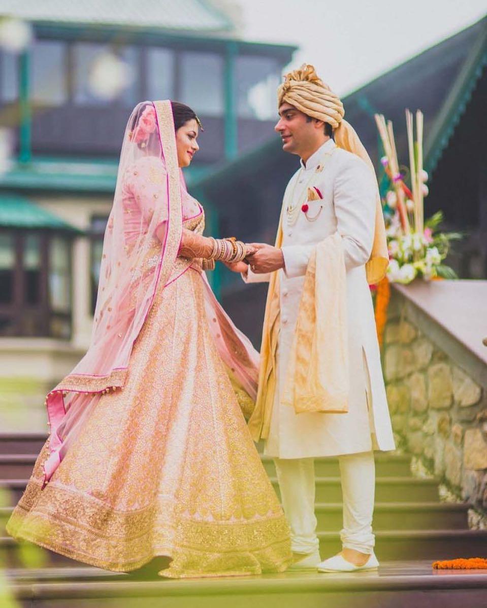 DUSTY PINK BUTI WORK LEHENGA SET WITH A HAND EMBROIDERED CUT OUT BLOUSE  PAIRED WITH A MATCHING RUFFLED DUPATTA AND SILVER EMBELLISHMENTS. - Seasons  India