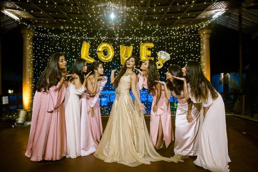 Photo of Bride in red lehenga posing on her wedding day.