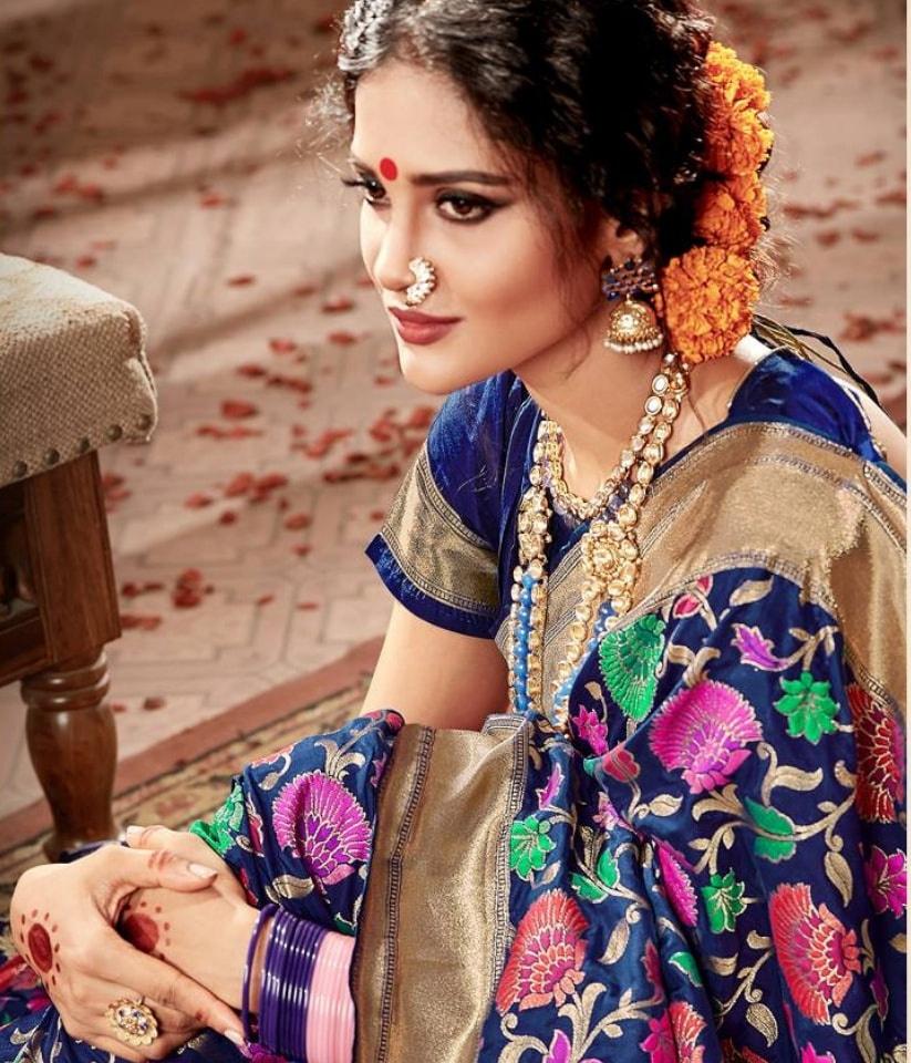 A PORTRAIT OF A MARATHI/MAHARASHTRIAN Bride dressed in traditional SAREE,  HOLDING A PUJA THALI/ CEREMONIAL VESSEL WITH A LIT LAMP Stock Photo - Alamy