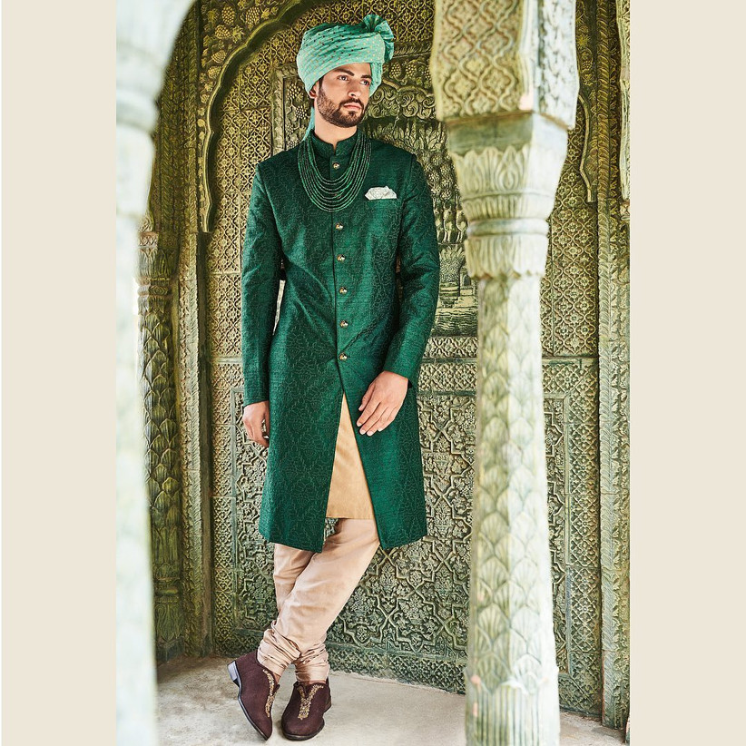 Groom Outfit Ideas To Complement A Bridal Red Lehenga Wedding dress on rent for groom is famous of sharma safa sherwani store. bridal red lehenga