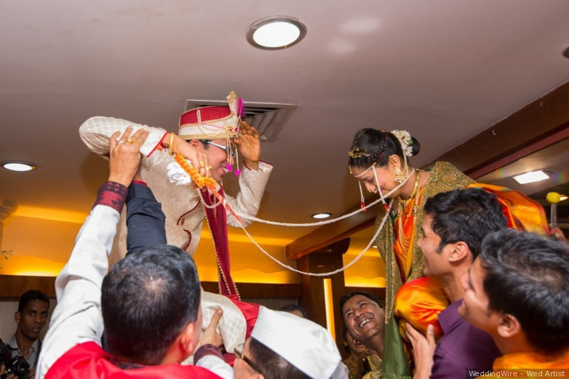 The groom and bride exchange Jaimala in a typical Maharashtrian wedding.