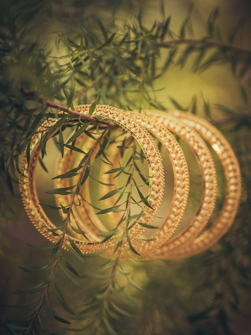 Palakka Bangle comes with leaf motifs and valuable gemstones that enhance the wrist of the Malayali bride.