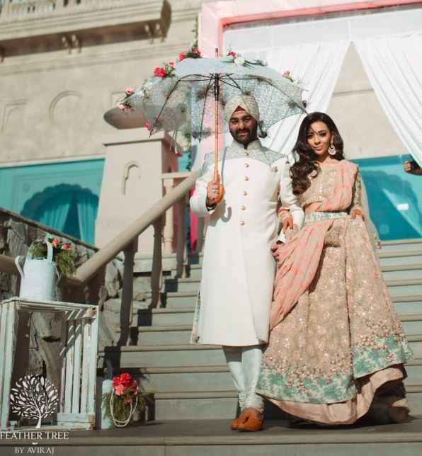 Bride and Groom walking in under an umbrella? - 1