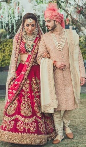 Bride wearing all red and groom all pink 1