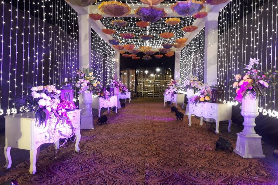 Gate to mandap with lighting