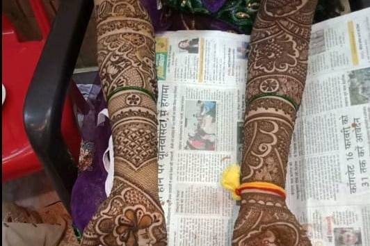 Mehndi artist drawing floral henna tattoo on woman hand in beauty salon.  Master applying traditional mehendi pattern for bride before wedding. Stock  Photo | Adobe Stock