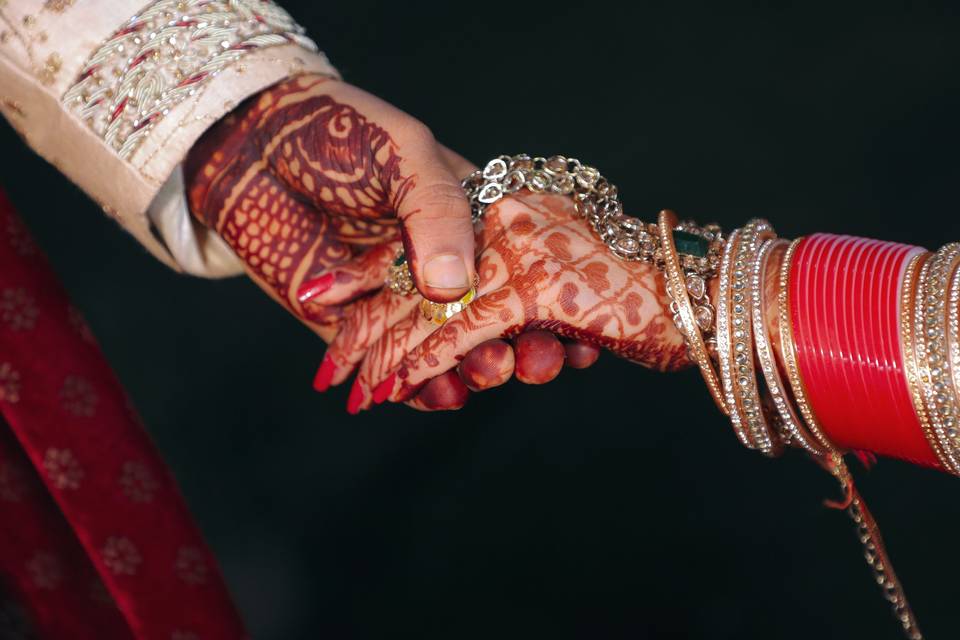 Bride and groom holding hands