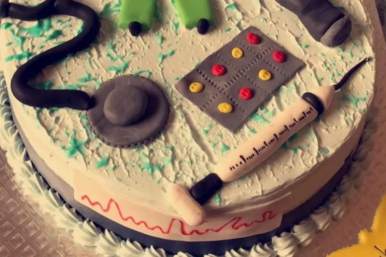 Premium Photo | Pastry chef decorating a purple frosted birthday cake with  text topping sprinkles pearls and butterflies